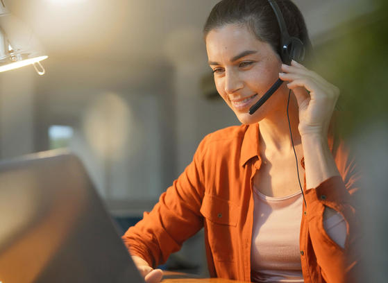 Female remote worker at home on call with headset