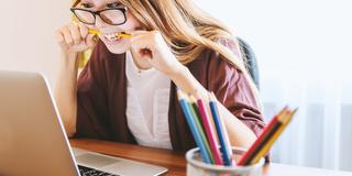 Frustrated woman looking at her laptop