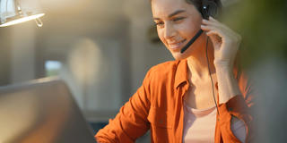 Female remote worker at home on call with headset