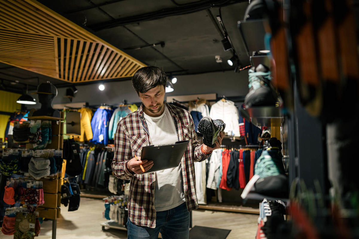 Man working in the retail industry checking inventory on his iPad