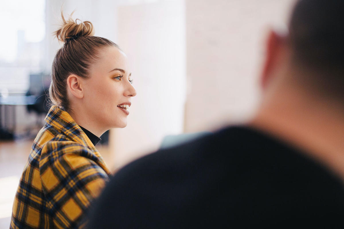 Close-up of woman and man discussing in an office