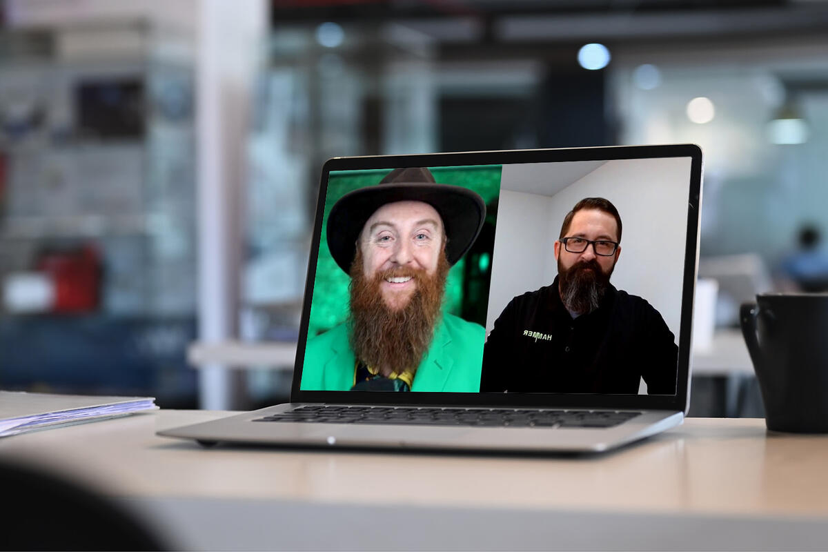 Laptop displaying the podcast 'How to Survive Your Cloud Migration' featuring Eric Day from Hammer and customer experience expert Nate Brown.