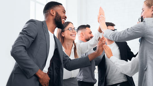 Happy team clapping each others hands