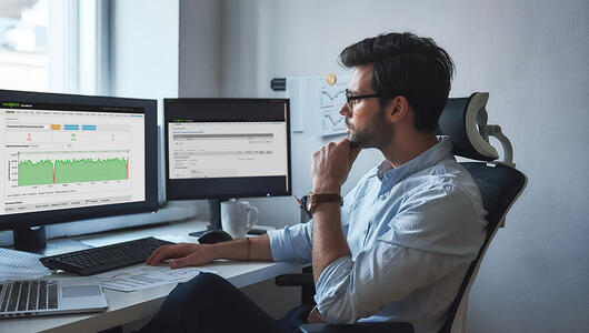 Man looking at VoiceWatch E2E performance reports