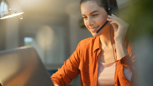 Female remote worker at home on call with headset