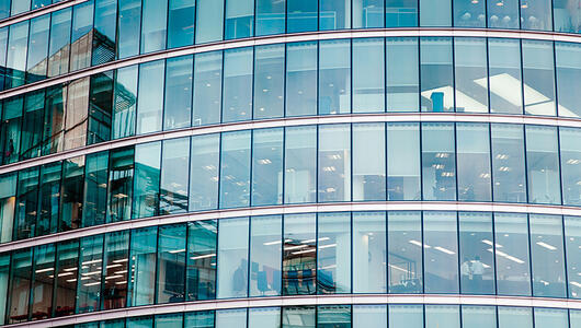 Closeup of financial building with corporate offices and employees