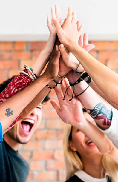 Team with hands together in the air showing success